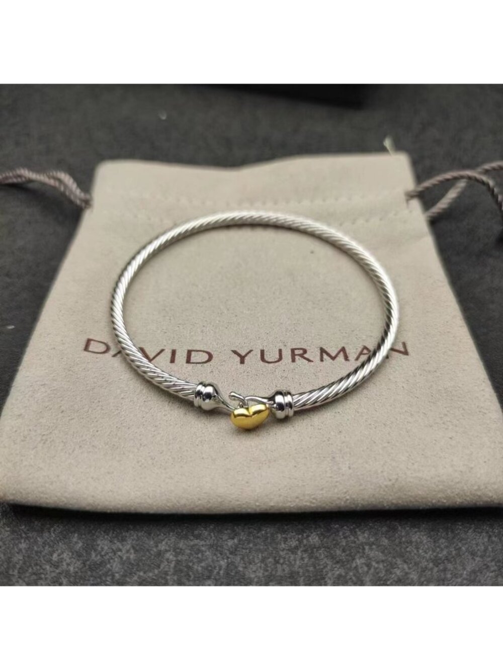 David Yurman's gold heart-shaped silver bracelet
